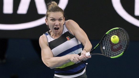 Romania&#039;s Simona Halep makes a backhand return to United States&#039; Serena Williams during their fourth round match at the Australian Open tennis championships in Melbourne, Australia, Monday,  ...