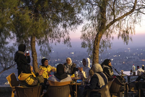 People gather to watch the sunset atop Mount Qassioun, which was opened to the public after the fall of the Assad regime, in Damascus, Syria, Thursday, Jan. 2, 2025. (AP Photo/Mosa&#039;ab Elshamy)