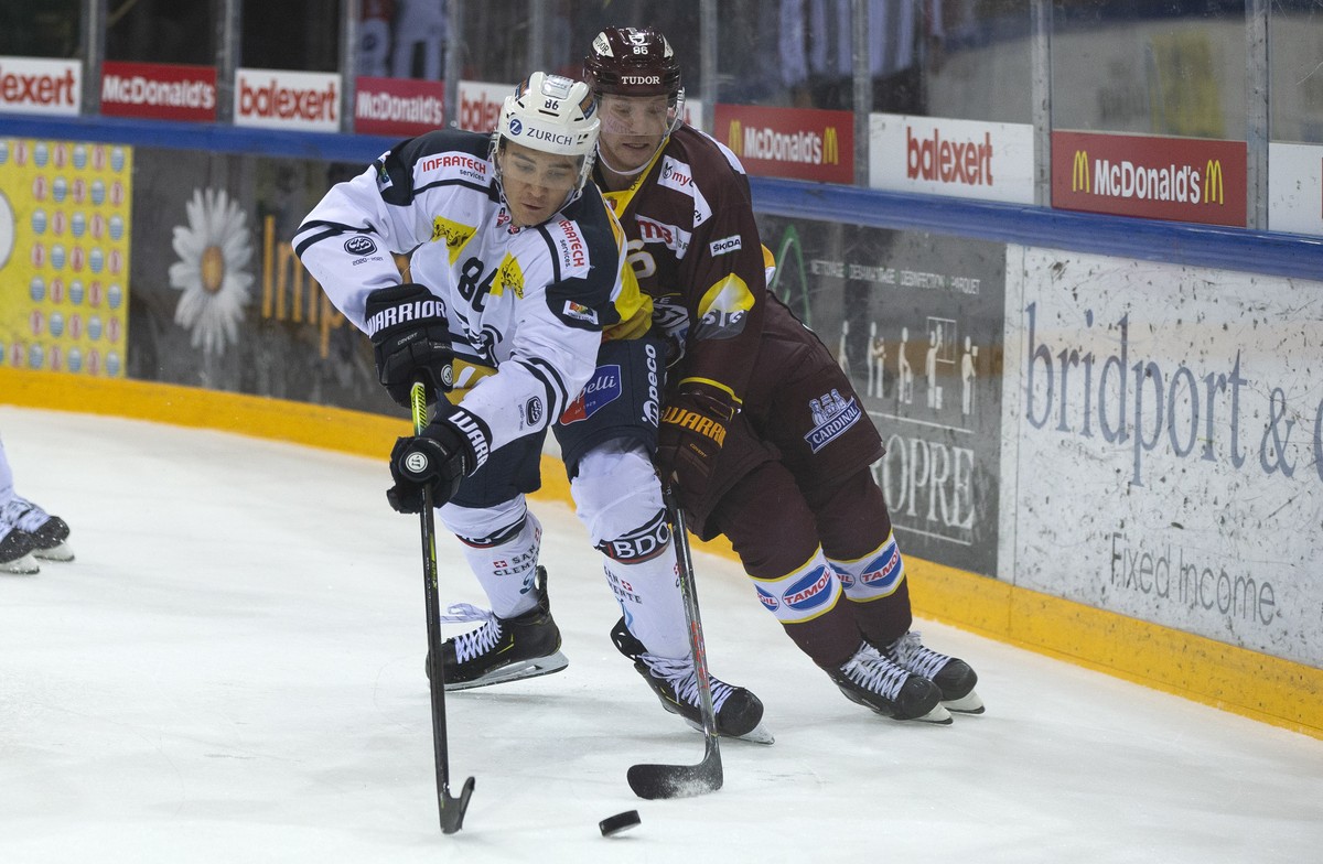 Ambri-Piotta's defender Rocco Pezzullo, left, vies for the puck with Geneve-Servette's center Joel Vermin, right, during a National League regular season game of the Swiss Championship betwe ...
