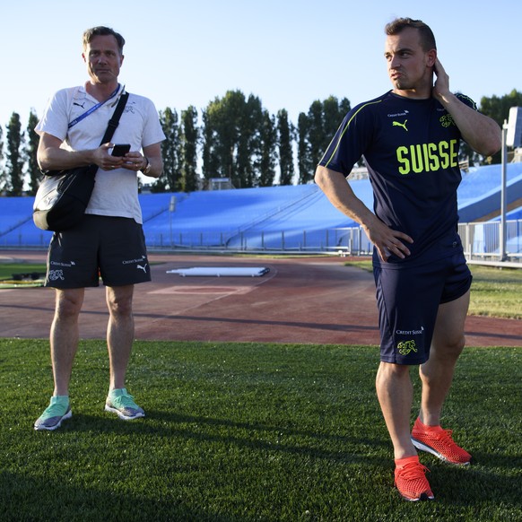 Switzerland&#039;s midfielder Xherdan Shaqiri, right, and Alex Miescher, left, General Secretary of the Swiss Footbal Association, SFA, and Head of Mission are pictured after a training session of the ...