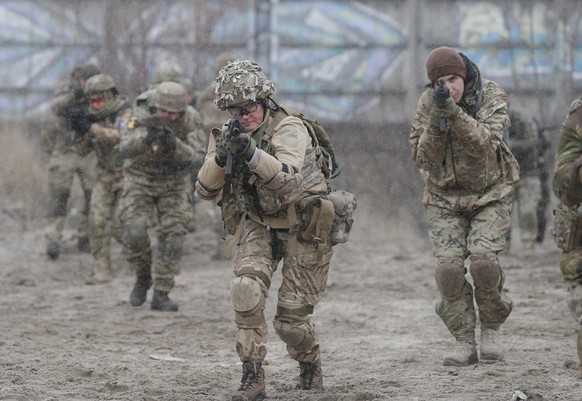 epa09649517 Ukrainian reservists attend a military exercise at a training ground near Kiev, Ukraine, 18 December 2021 (issued 19 December 2021). According to a survey conducted by the Kiev Internation ...