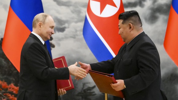 FILE - Russian President Vladimir Putin and North Korean leader Kim Jong Un exchange documents during a signing ceremony of a new partnership in Pyongyang, North Korea, on June 19, 2024. (Kristina Kor ...