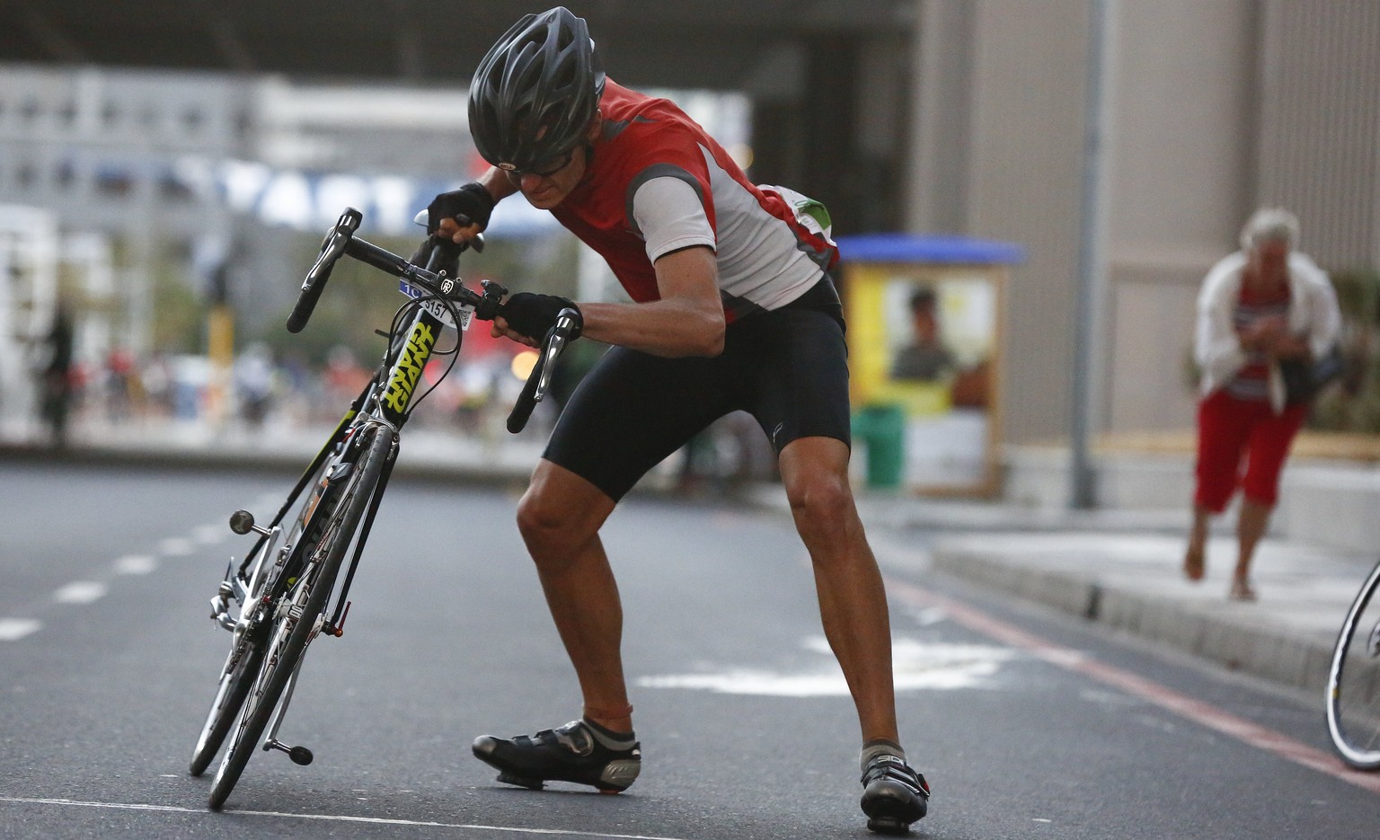 epa05843800 A cyclist battles against gale force winds at the start of the worlds largest timed cycle race the Cape Town Cycle Tour in Cape Town, South Africa 12 March 2017. In its 40th year the race  ...