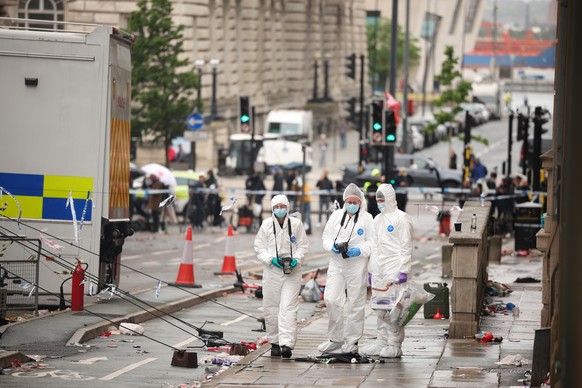epa12138323 Forensics officers at the scene where a car collided with people during the Liverpool FC trophy parade in Liverpool city centre, Britain, 27 May 2025. A 53-year-old British man has been de ...