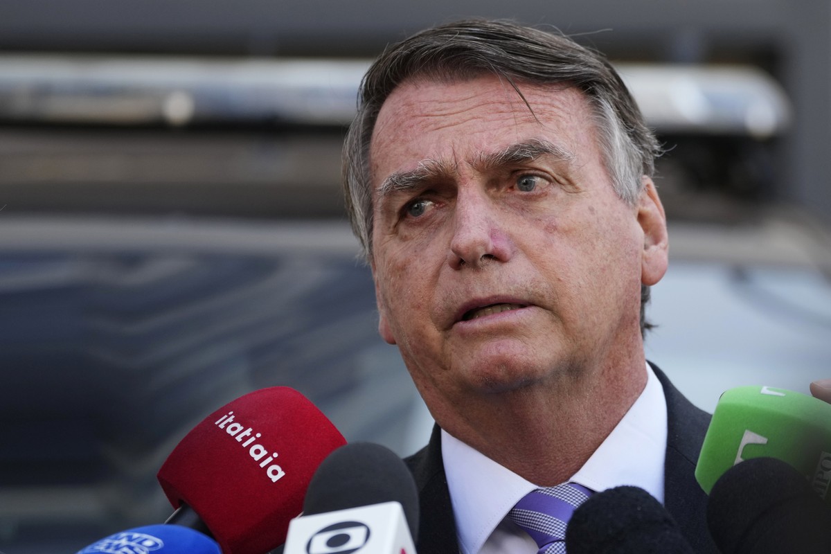 Brazil's former President Jair Bolsonaro speaks to the press as he leaves the Federal Police headquarters where he gave testimony about his actions related to the Jan. 8 attacks on government bui ...