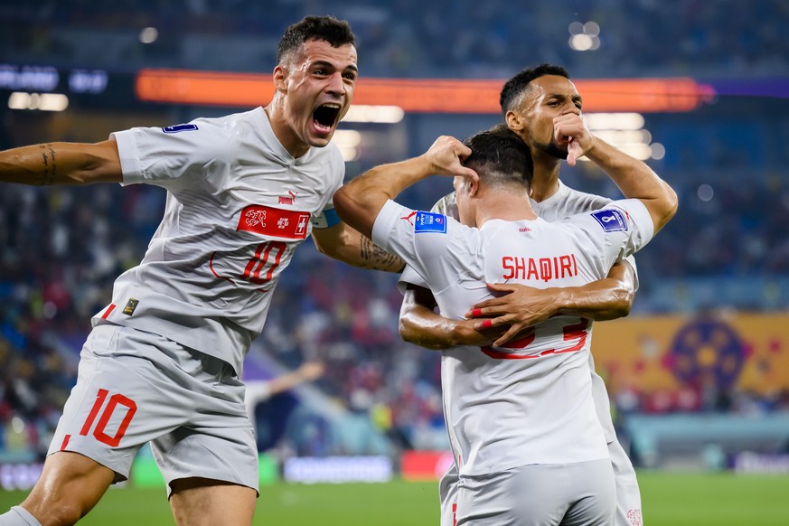 Switzerland's midfielder Xherdan Shaqiri, center, celebrates after scoring the first goal with Switzerland's midfielder Granit Xhaka, left, and Switzerland's midfielder Djibril Sow, right, during the  ...