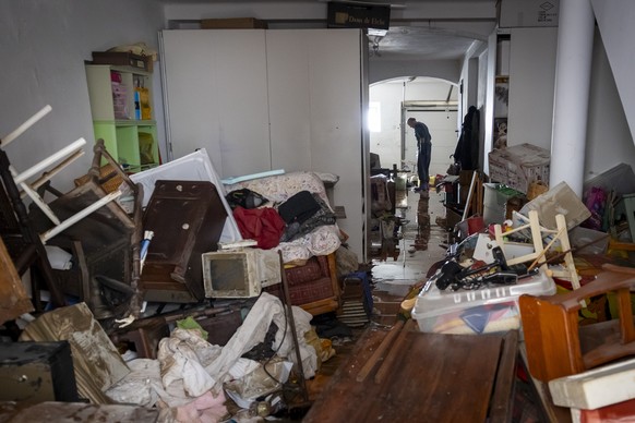 epa12709478 A man inspects his flooded garage in the riverside area in Alcacer do Sal, Setubal, Portugal, 06 February 2026. Thirteen people have died in Portugal since last week as a result of storms  ...