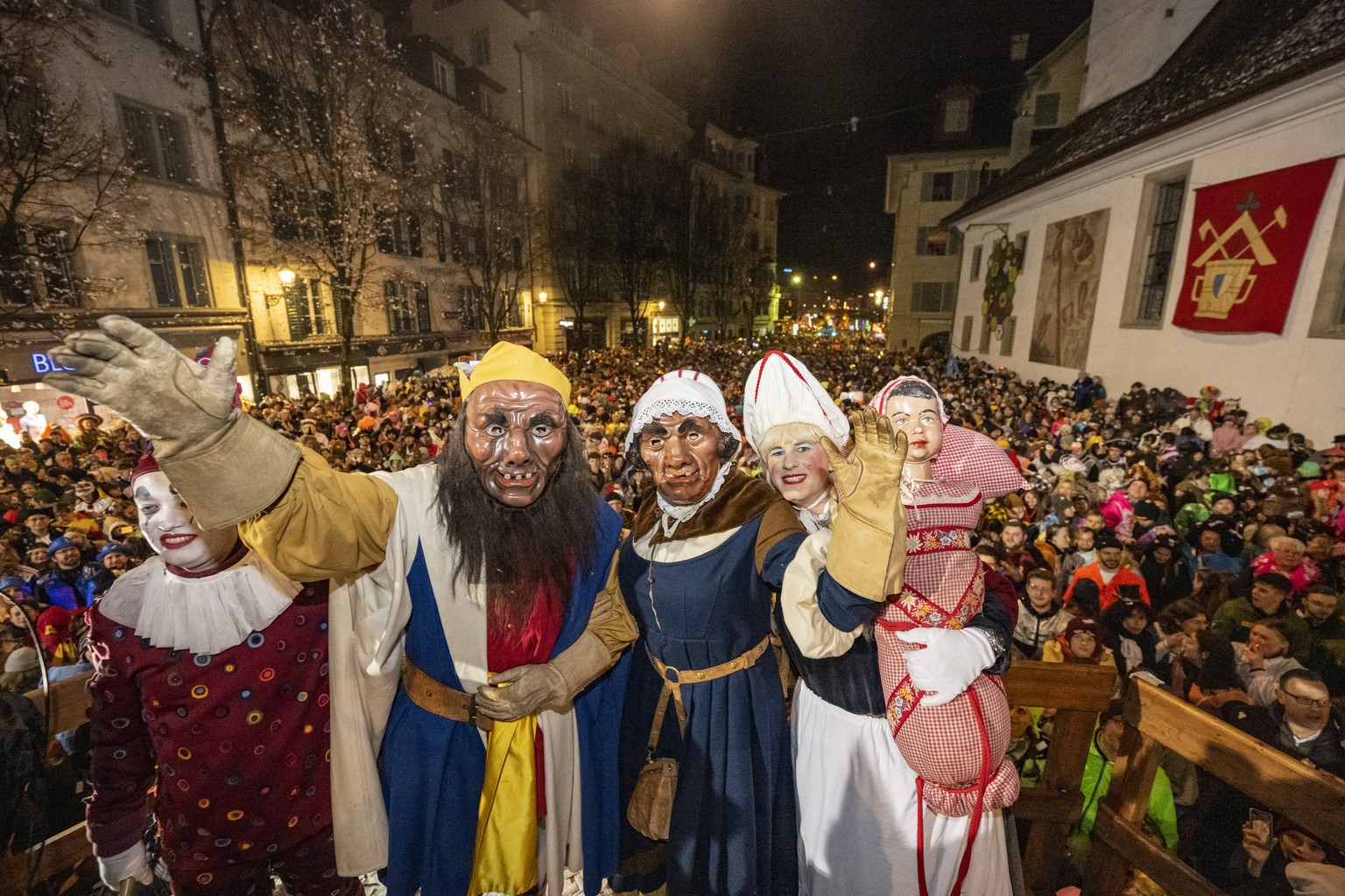 Der Fritschi und seine Familie geniessen den &#039;Foetzeliraege&#039; auf dem Kapellplatz an der Fritschi-Tagwache der Luzerner Fasnacht am Schmutzigen Donnerstag, 8. Februar 2024 in Luzern. Die Luze ...
