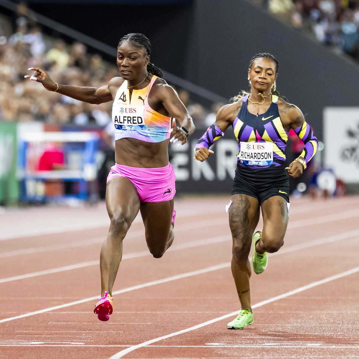 The winner Julien Alfred of Saint Lucia, center, crosses the finish line next to Amy Hunt of United Kingdom, left, and Sha'Carri Richardson of United States, right, during the women's 100 me ...