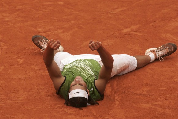 PARIS - JUNE 5: Rafael Nadal gestures as he lies on court after match point to win the Men's Final match against Mariano Puerta of Argentina on the fourteenth day of the French Open on June 5, 20 ...