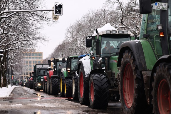 epa11064304 Tractors on a street as German farmers demonstrate during a nationwide farmers&#039; strike, in Munich, Germany, 08 January 2024. Farmers went on strike nationwide in Germany, in protest a ...