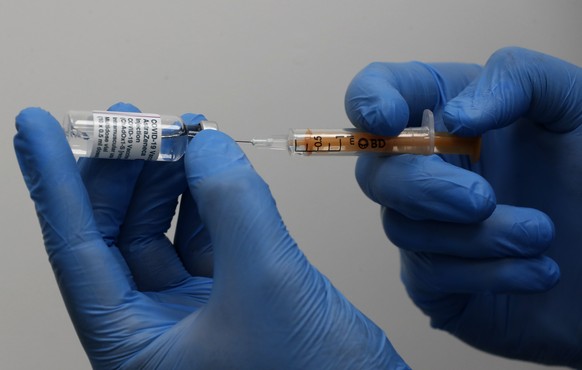 Doctor Khizer Hanif prepares the AstraZeneca vaccine at a Pharmacy in Edgeware, London, Tuesday, March 16, 2021, as Britain continues use of the vaccine. In recent days, countries including Denmark, I ...