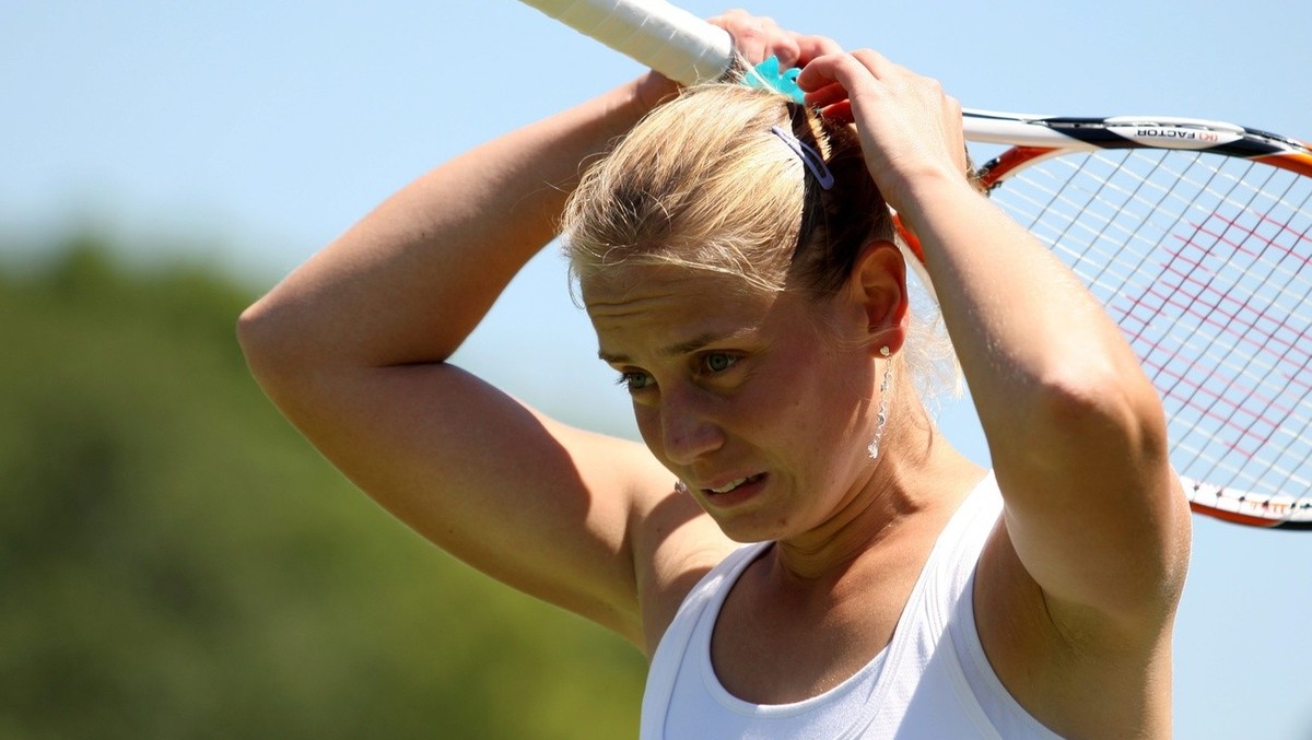 epa01770863 Jelena Dokic of Australia reacts during her first round match against Tatjana Malek of Germany for the Wimbledon Championships at the All England Lawn Tennis Club, in London, Britain, 23 J ...