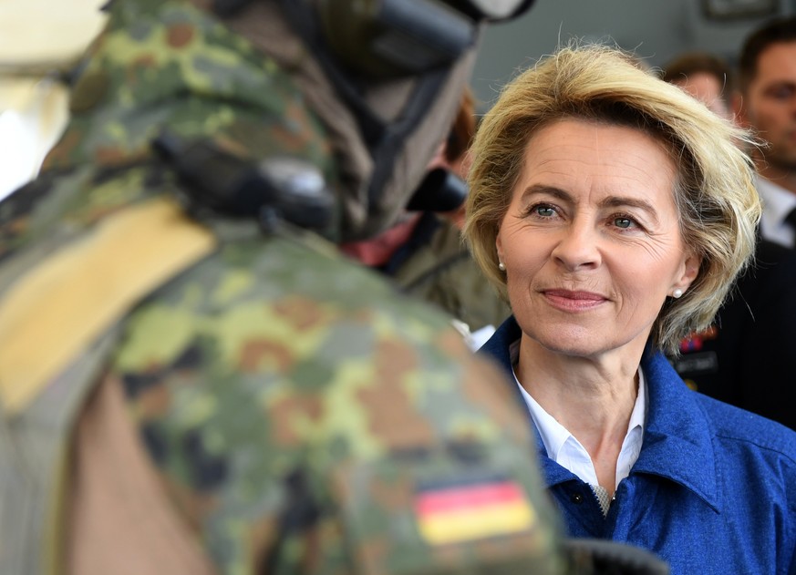 epa05940560 (FILE) - A file photograph showing German Defence Minister Ursula von der Leyen (R) listens to a soldier of the German special naval forces (L) during a visit of a corvette of the German N ...