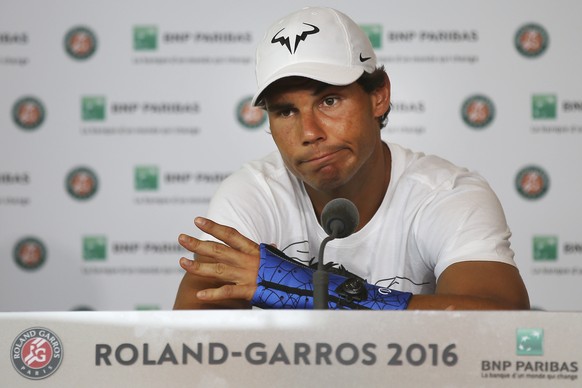 FILE - In this Friday, May 27, 2016 file photo, nine-time champion Rafael Nadal announces he is pulling out of the French Open because of an injury to his left wrist during a press conference at the R ...
