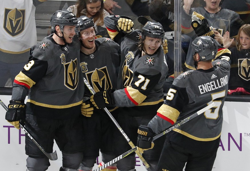 Vegas Golden Knights players celebrate after center William Karlsson (71) scored against the San Jose Sharks during the third period of an NHL hockey game, Saturday, March 31, 2018, in Las Vegas. Vega ...