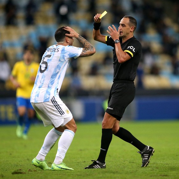RIO DE JANEIRO, BRAZIL - JULY 10: Leandro Paredes of Argentina is sanctioned by the referee Esteban Ostojich with a yellow card for the foul ,during the Final Match of Copa America Brazil 2021 between ...