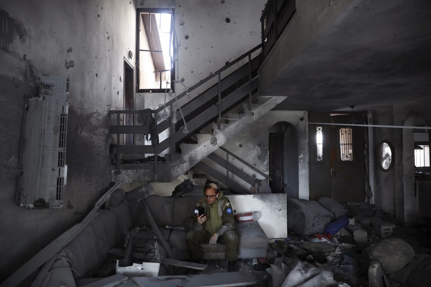 An Israeli soldier from the IDF Spokesperson&#039;s Unit inspects the damaged house after it was hit by a rocket fired from the Gaza Strip, In Ashkelon, Israel, Thursday, May 20, 2021. (AP Photo/Ariel ...