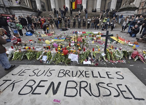 FILE - A banner for the victims of the bombings reads &quot;I am Brussels&quot; at the Place de la Bourse in the center of Brussels, March 23, 2016. The trial of 10 men accused over the 2016 suicide b ...