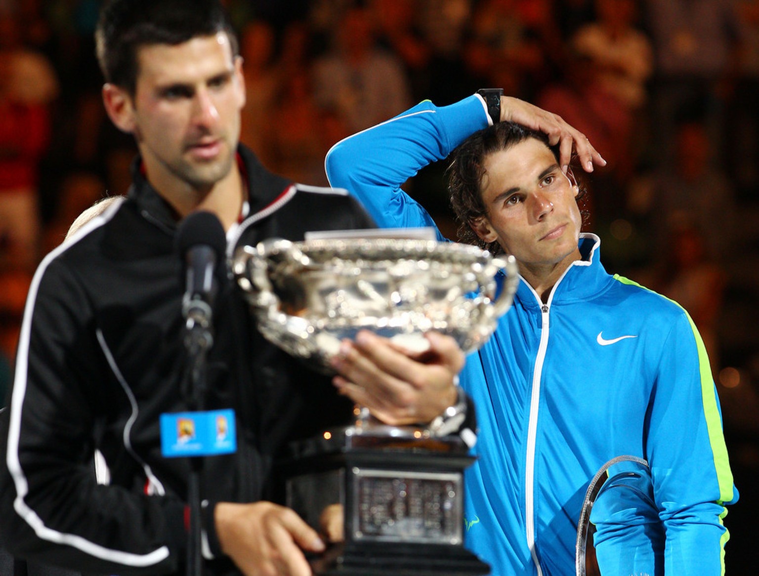 Spain&#039;s Rafael Nadal, right, looks on as Serbia&#039;s Novak Djokovic addresses the crowd after winning the men&#039;s singles final against at the Australian Open tennis championship, in Melbour ...