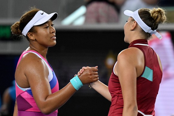 epa09699412 Naomi Osaka of Japan (L) shakes hands with Amanda Anisimova of the USA following her loss in their third round Women?s singles match on Day 5 of the Australian Open Tennis Tournament at Me ...