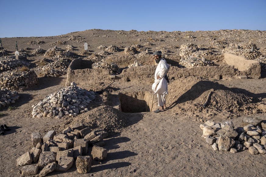 An Afghan man prepares a grave for one of the earthquake victims in Zenda Jan district in Herat province, western of Afghanistan, Sunday, Oct. 8, 2023. Powerful earthquakes killed at least 2,000 peopl ...