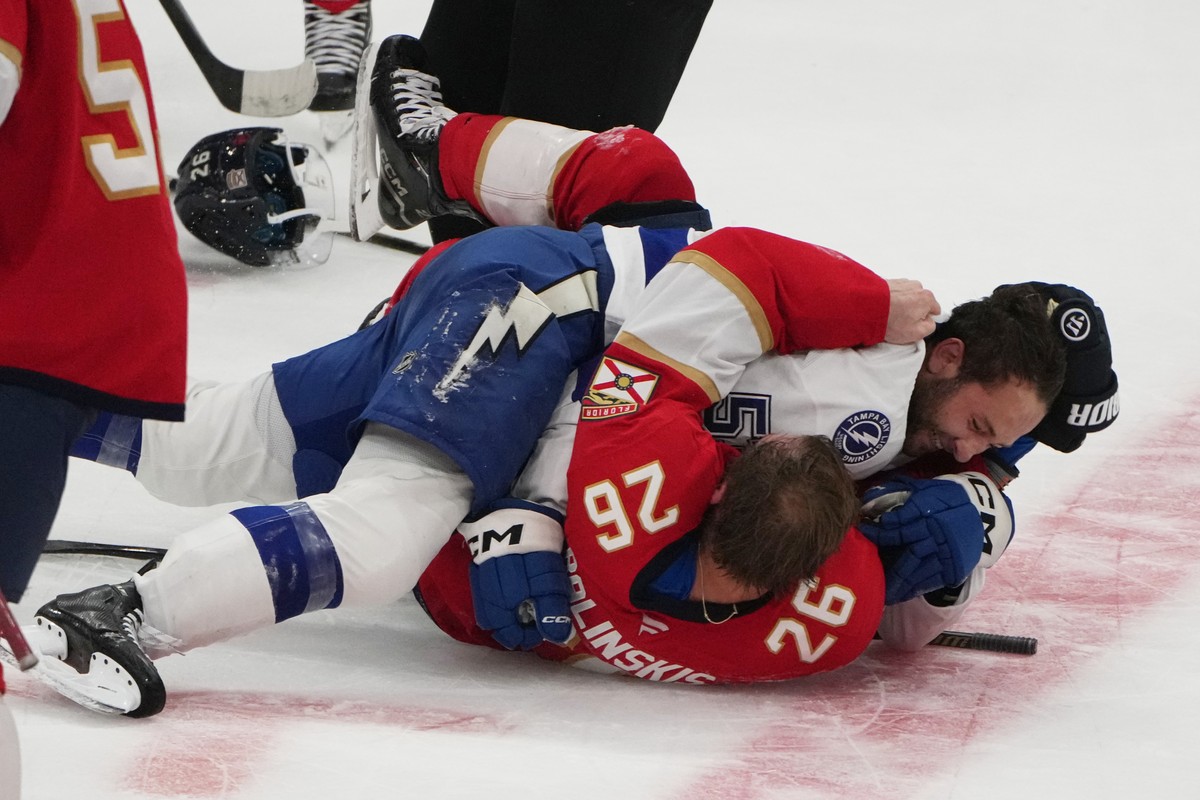 Florida Panthers defenseman Uvis Balinskis (26) and Tampa Bay Lightning Dylan Duke, right, scuffle during the third period of an NHL hockey preseason game, Saturday, Oct. 4, 2025, in Sunrise, Fla. (AP ...
