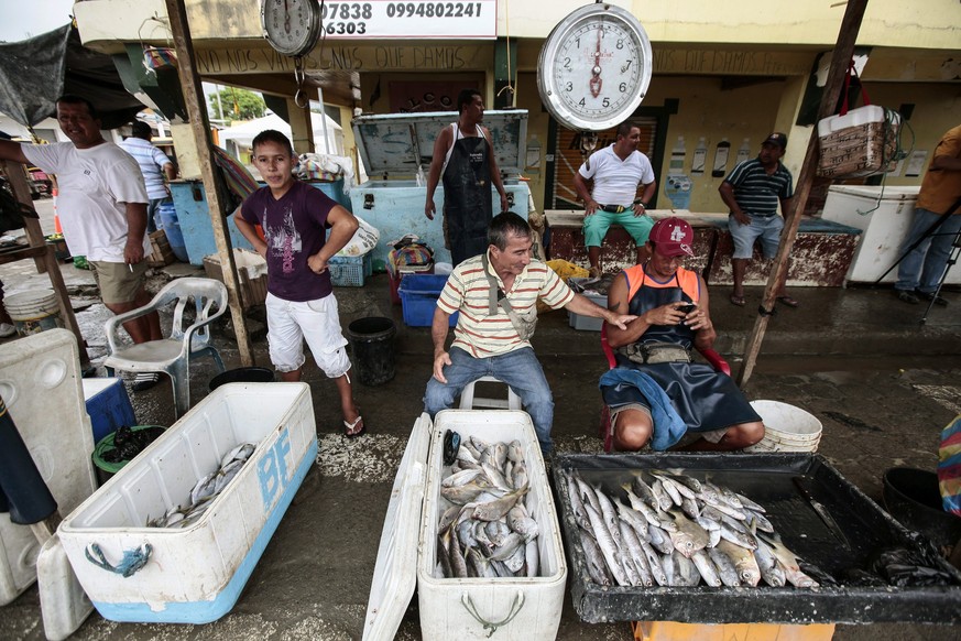 epa05309416 A picture made available on 16 May 2016 shows vendors waiting for clients in Pedernales, Ecuador, on 14 May 2016. Fish vendors will be relocated in the new fish market after the old one wa ...