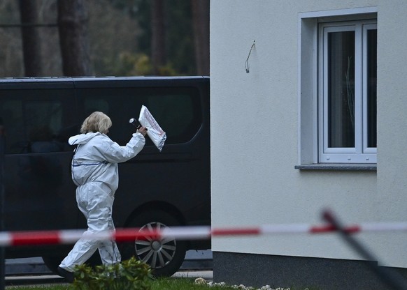 A forensic scientist goes to a single-family house in Senzig, a district of the town of Koenigs Wusterhausen in the Dahme-Spreewald district, Saturday, Dec.4, 2021. Police have found five dead bodies  ...
