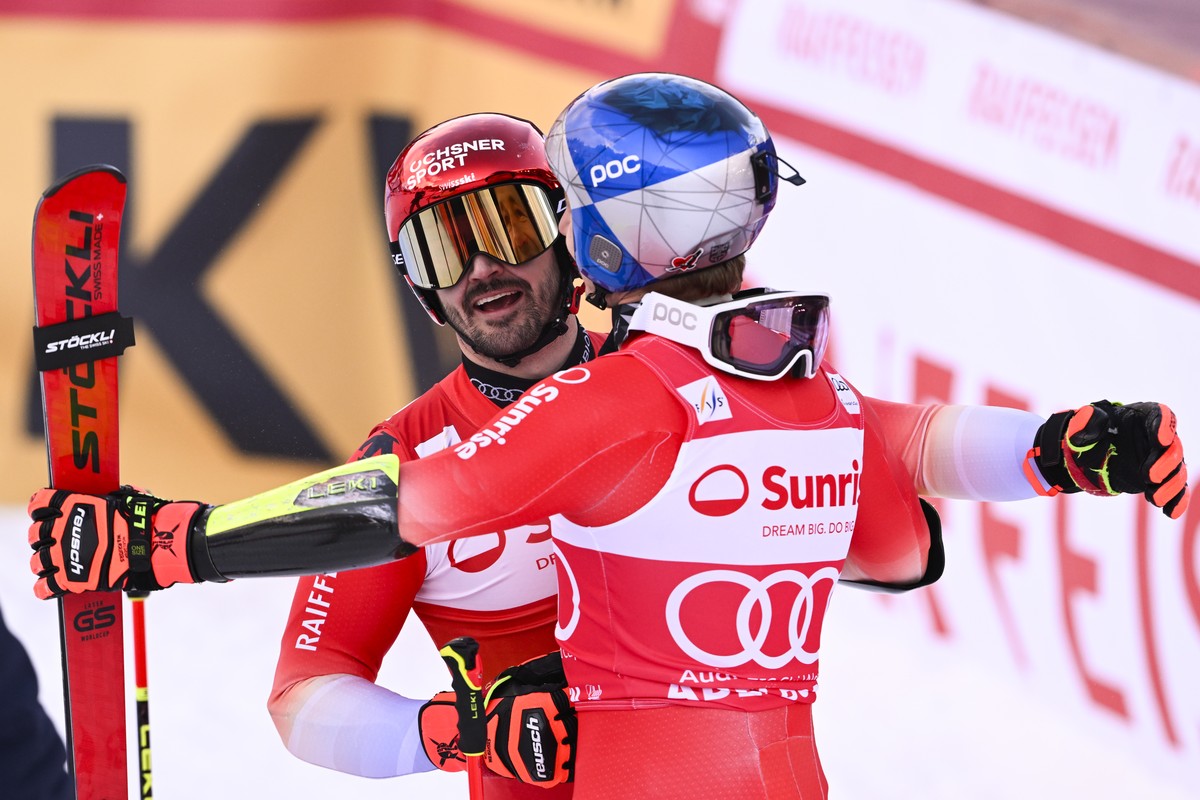 Second placed Loic Meillard of Switzerland, left, and winner Marco Odermatt of Switzerland react during the second run of the men's Giant Slalom race at the Alpine Skiing FIS Ski World Cup, in Ad ...