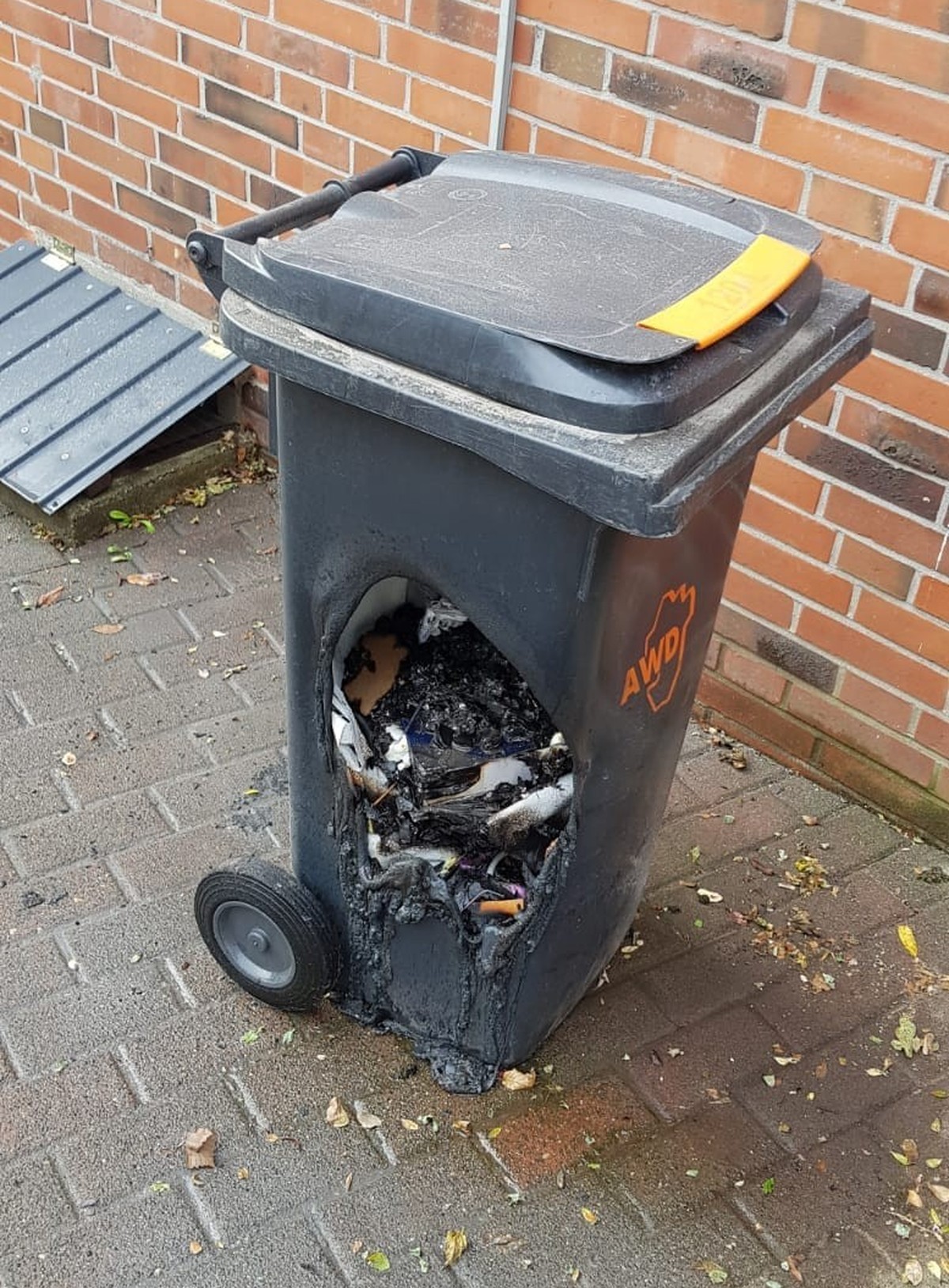 Heisse Grillkohle hat Plastikcontainer geschmolzen