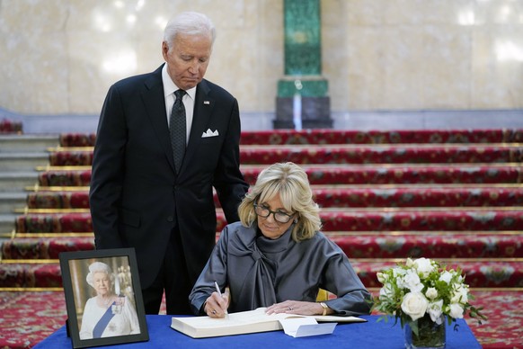 First lady Jill Biden signs a book of condolence at Lancaster House in London, following the death of Queen Elizabeth II, Sunday, Sept. 18, 2022, as President Joe Biden looks on. (AP Photo/Susan Walsh ...