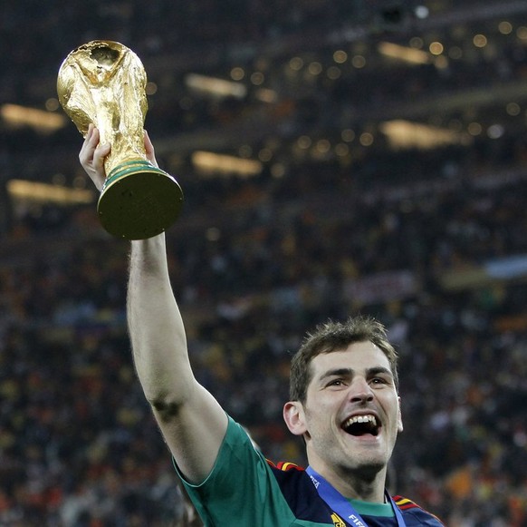Spain's Iker Casillas celebrates with the trophy during the 2010 FIFA soccer World Cup final between the Netherlands and Spain in the Soccer City Stadium in Johannesburg, South Africa, pictured o ...