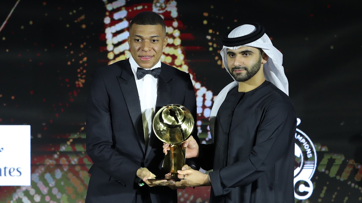 epa09658026 H.H. Sheikh Mansoor Bin Mohammed Bin Rashid Al Maktoum (R), Chairman of Dubai Sports Council gives Paris St. Germain's French player Kylian Mbappe (L) the award for the best Men' ...