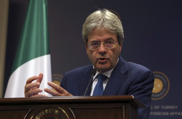 FILE - In this Thursday, Oct. 6, 2016 file photo, Italian Foreign Minister Paolo Gentiloni talks during a joint press conference with Turkish foreign Minister Mevlut Cavusoglu, in Ankara. Italy&#039;s ...