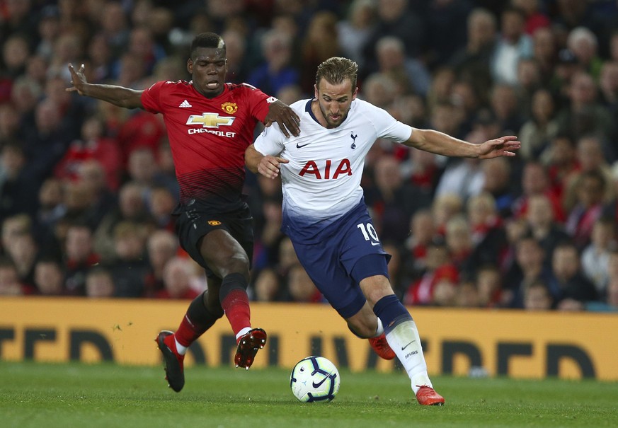 Tottenham Hotspur's Harry Kane, right, is challenged by Manchester United's Paul Pogba during the English Premier League soccer match between Manchester United and Tottenham Hotspur at Old T ...