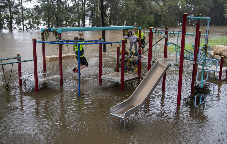 People play on equipment at a playground on the banks of the Nepean River at Jamisontown on the western outskirts of Sydney Monday, March 22, 2021. Australia's most populous state of New South Wa ...