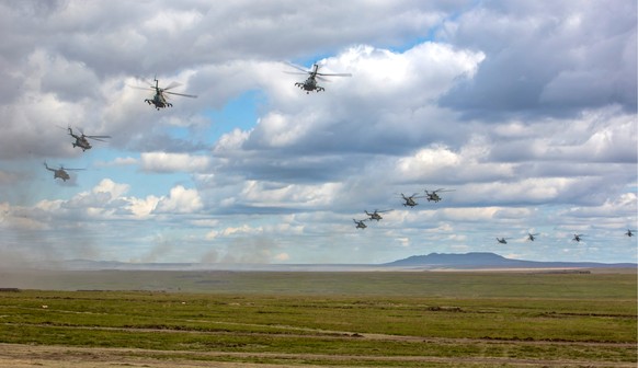 In this photo provided by Russian Defense Ministry Press Service on Tuesday, Sept. 11, 2018. Russian military helicopters fly, in the Chita region, Eastern Siberia, during the Vostok 2018 exercises in ...
