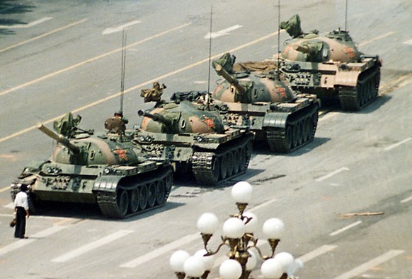 A Chinese man stands infront of tanks heading down Cangan Boulevard, past the Beijing Hotel, near Tiananmen Square, China, 5th June 1989. The tanks stopped their advance momentarily as he cried and pl ...