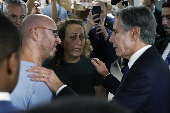 U.S. Secretary of State Antony Blinken speaks with people as he visits a donation center for victims of the Hamas terror attacks, Thursday Oct. 12, 2023, in Tel Aviv. (AP Photo/Jacquelyn Martin, pool) ...