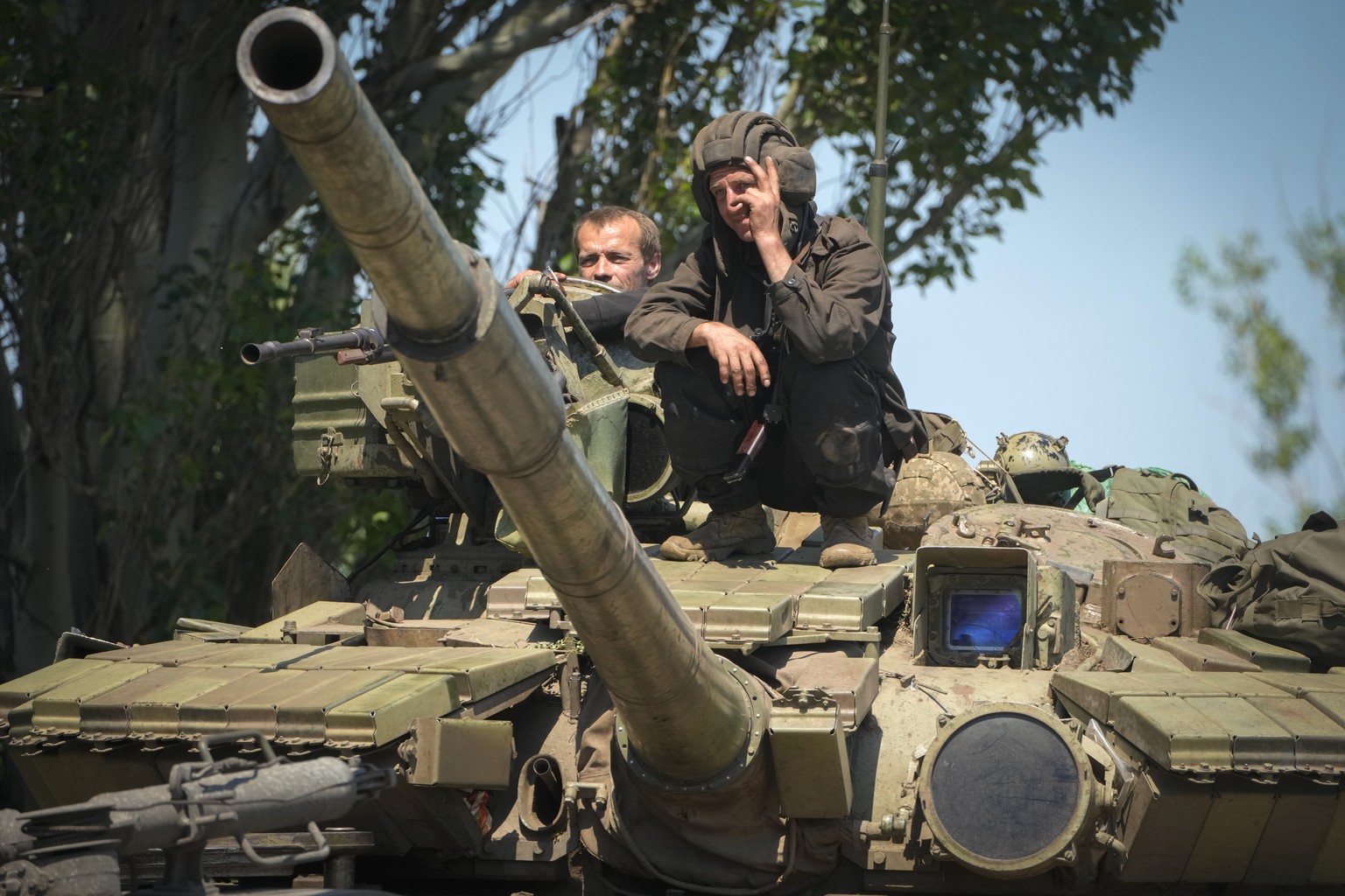A Ukrainian soldier flashes the victory sign atop a tank in Donetsk region, Ukraine, Monday, June 20, 2022. (AP Photo/Efrem Lukatsky)
