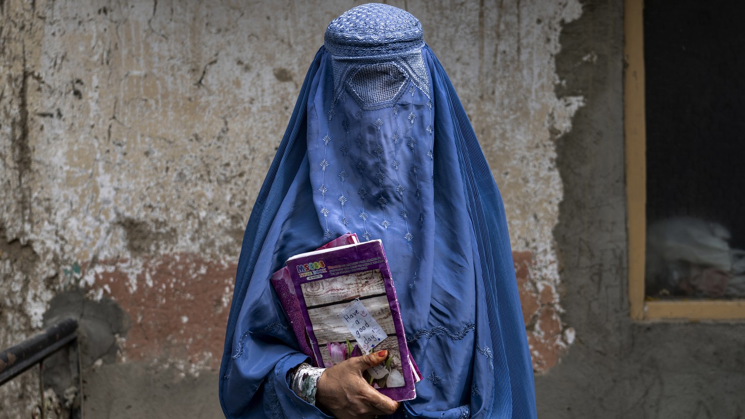 FILE- Arefeh 40-year-old, an Afghan woman leaves an underground school, in Kabul, Afghanistan, Saturday, July 30, 2022. Afghanistan&#039;s higher education minister Nida Mohammed Nadim on Saturday, Au ...