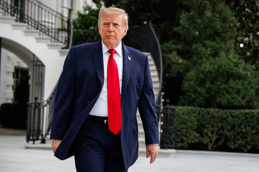 epa13264650 US President Donald Trump walks out of the South Portico towards members of the press before departing from the new South Lawn helipad in Marine One at the White House in Washington, DC, U ...