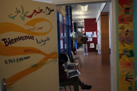 Men take a rest in the &quot;Aurore&quot; center for homeless and migrants in Paris, Thursday, April 2, 2020. Despite the confinement period in a bid to brake the spread of the Covid-19, the associati ...