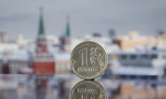 epa09863437 A photo illustration shows a Russian ruble coin in Moscow, Russia, 01 April 2022. Russian President Putin announced on 31 March that he signed a decree on transitioning to payments for Rus ...