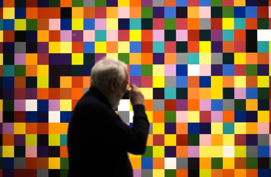People look at painting '4900 Colors (fragment)' in a new exhibition of artwork by German artist Gerhard Richter at the New National Gallery in Berlin, Germany, Friday, March 31, 2023. ...