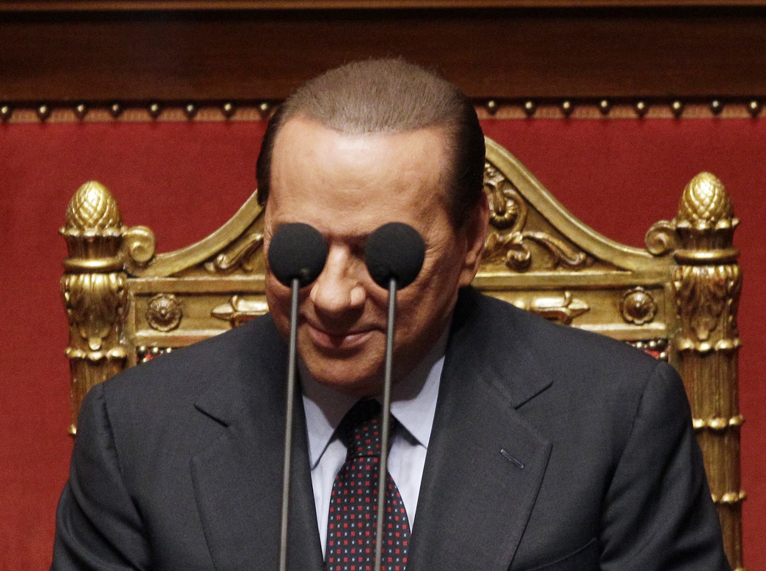 FILE - Italian Premier Silvio Berlusconi is framed by microphones prior to deliver his speech at the Italian Senate, Thursday, Sept. 30, 2010. Italy is poised to elect a new president, a figure who is ...