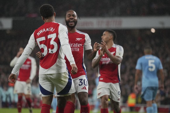 Arsenal&#039;s Ethan Nwaneri celebrates with teammates after scoring his side&#039;s third goal during the English Premier League soccer match between Arsenal and Nottingham Forest at Emirates Stadium ...