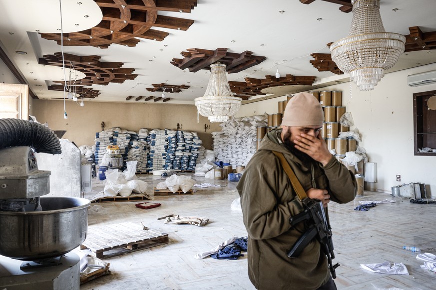 epa11789250 A soldier guards a room of the property where an illicit drug called captagon was discovered, hidden inside mothballs at the warehouse where it was manufactured before the ouster of Syrian ...