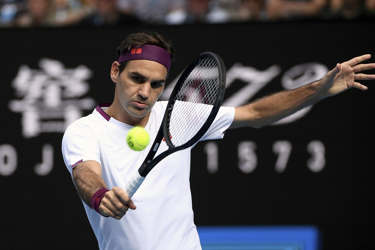FILE - In this Jan. 28, 2020, file photo, Switzerland's Roger Federer makes a backhand return to Tennys Sandgren, of the United States, during their quarterfinal match at the Australian Open tenn ...